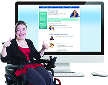 A woman sitting in a wheelchair in front of a computer screen with an Easy Read website. She is giving a thumbs up. 