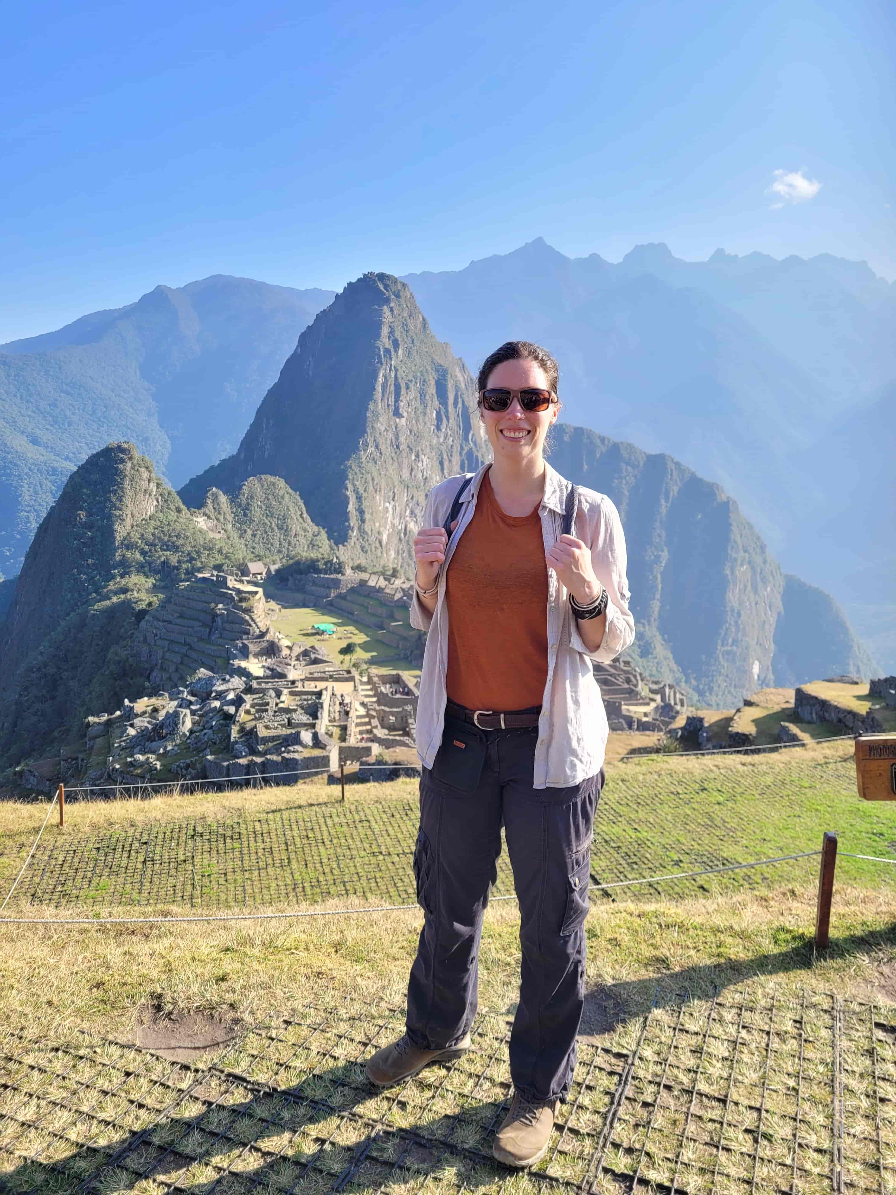 Catie standing in the foreground of mountains.