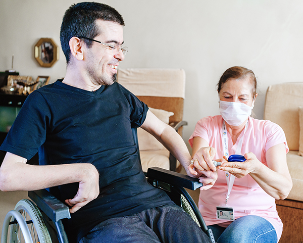 a man with disability receiving care from a health professional