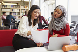 Two women reading a document