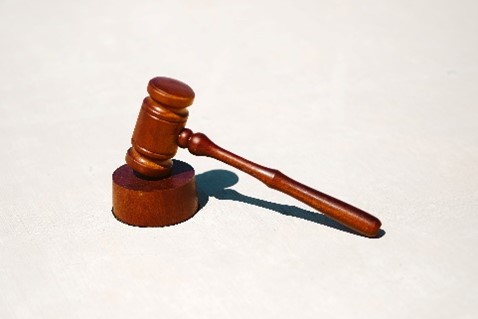 A picture of a gavel, or a judge's hammer. 