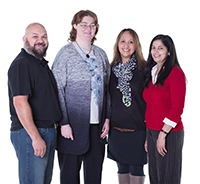 Four people standing together